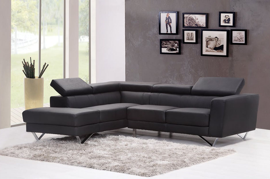 Dark grey sofa in a room with paintings on the wall